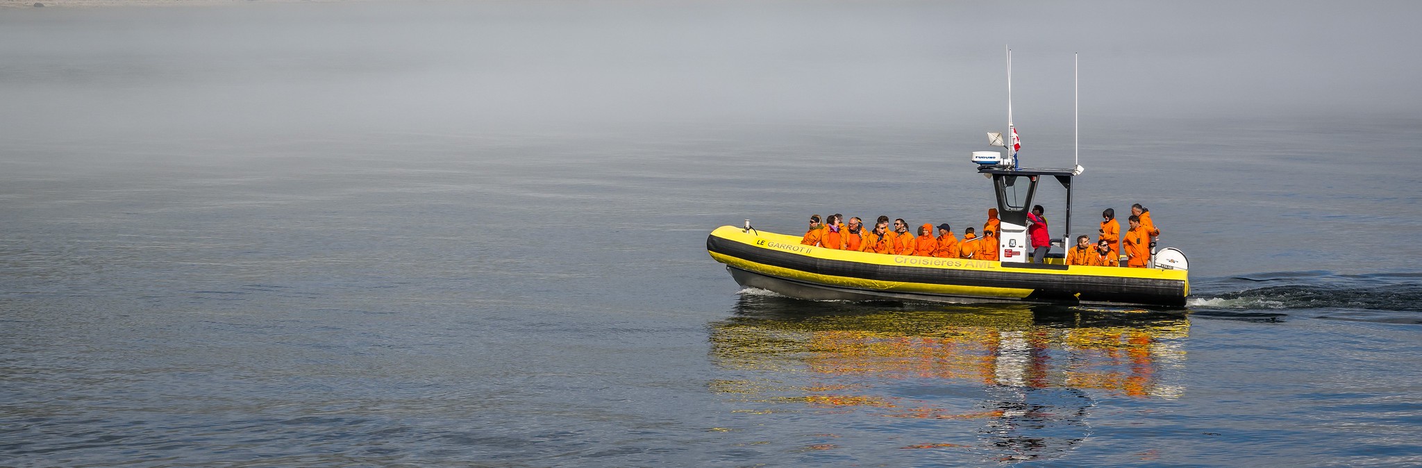 Tourists on whale watching tour in Tadoussac